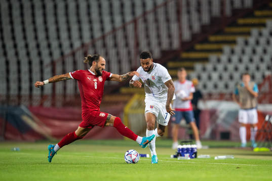 Nemanja Gudelj of Serbia and Joshua King of Norway