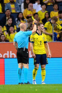 Emil Krafth of Sweden is shown a yellow card