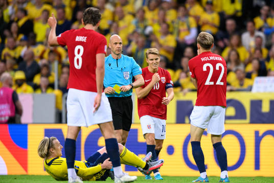Marcus Holmgren Pedersen of Norway receives a yellow card