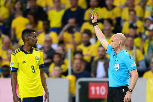 Alexander Isak of Sweden is shown a yellow card by referee