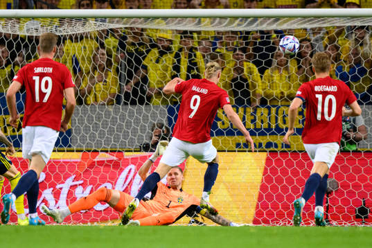 Goalkeeper Robin Olsen of Sweden saves a shot from Erling