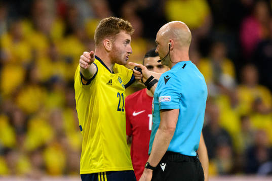 Dejan Kulusevski of Sweden talks to referee Anthony Taylor