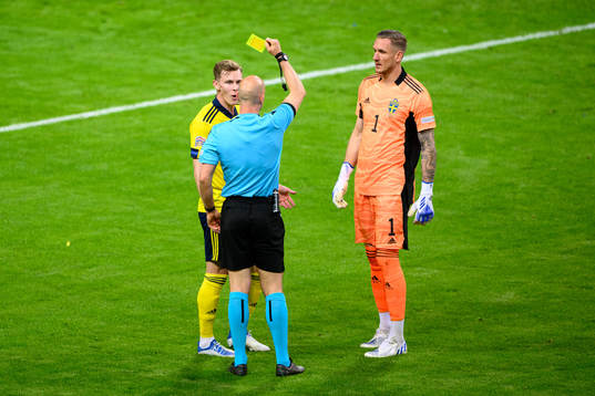 Emil Krafth of Sweden is shown a yellow card