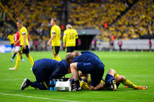 Viktor Claesson of Sweden receives medical attention