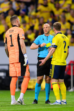 goalkeeper Robin Olsen and Emil Krafth talks to the referee