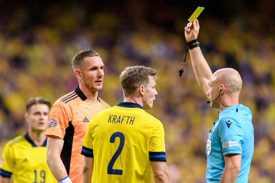 Emil Krafth of Sweden is shown a yellow card