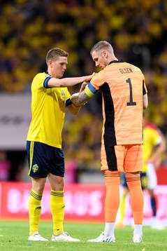 Joakim Nilsson and goalkeeper Robin Olsen of Sweden