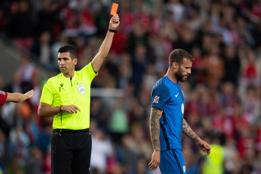 Miha Blazic of Slovenia is shown a red card