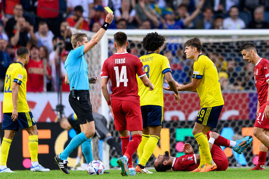 Mattias Svanberg of Sweden is shown a yellow card