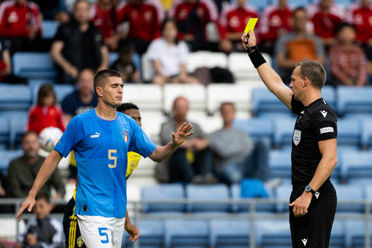 Lorenzo Pirola of Italy is shown a yellow card by referee