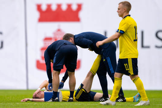 Patrik Wålemark of Sweden receives medical attention