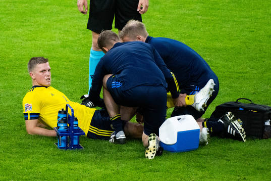 Joakim Nilsson of Sweden receives medical attentionduring