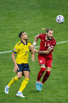Robin Quaison of Sweden and Nemanja Gudelj of Serbia