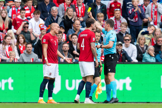 Leo Østigård of Norway receives a yellow card