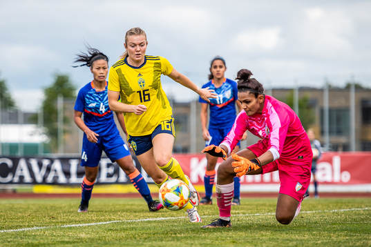 Beata Olsson of Sweden and goalkeeper Aditi Chauhan of India