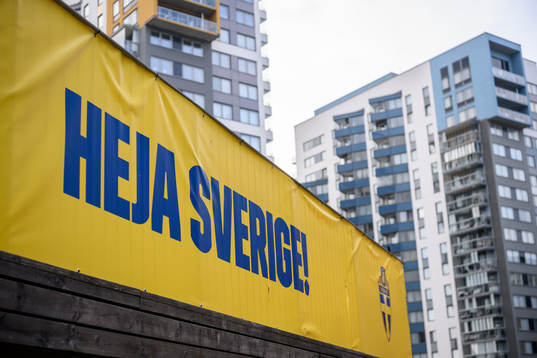 A banner with ”heja sverige” outside of the arena