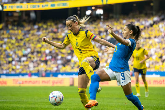 Kosovare Asllani of Sweden and Debinha of Brazil