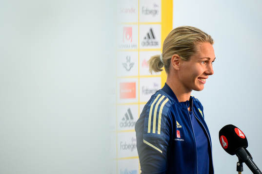 Goalkeeper Jennifer Falk is interviewed by the media