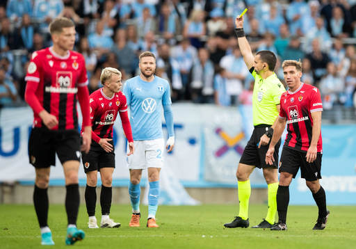 Kristall Mani Ingason of Vikingur receives a yellow card