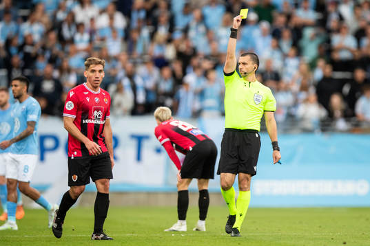 Pablo Punyed of Vikingur receives a yellow card from