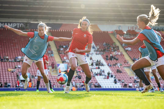 Ada Hegerberg and Ingrid Syrstad Engen of Norway warms up