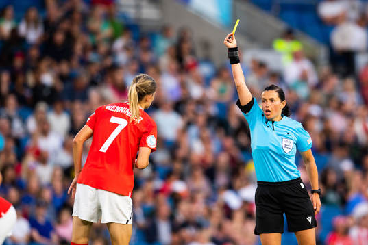 Carina Wenninger of Austria is shown a yellow card by