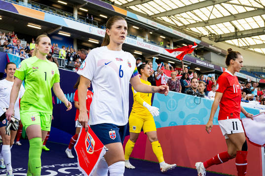 Goalkeeper Guro Pettersen and Maren Mjelde of Norway enter