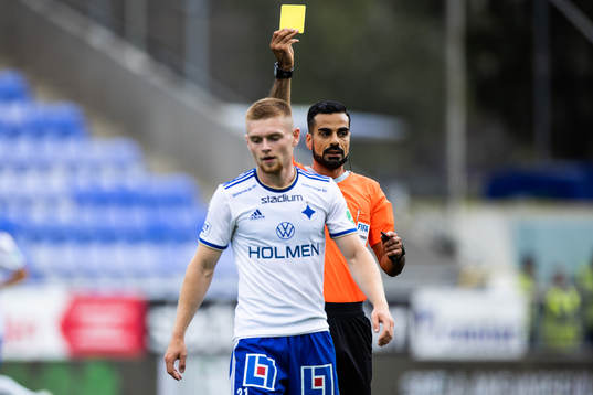 domare Mohammed Al-Hakim delar ut ett gult kort till IFK