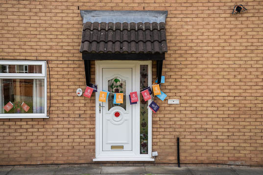 A front door decorated with Euro 2022 flags