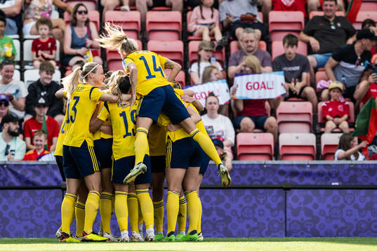 Players of Sweden celebrate scoring 2-0