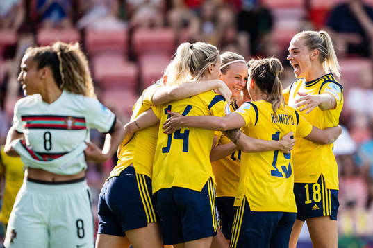 Players of Sweden celebrate scoring 3-0