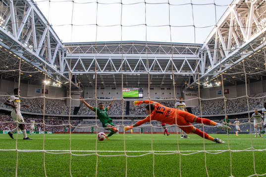 Marlyson Conceicao Olivera of Vorskla Poltava scores behind