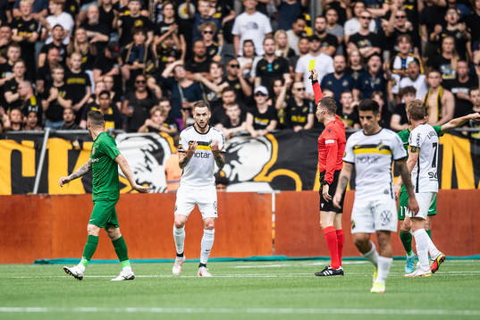 Alexander Milosevic of AIK recieves a yellow card from