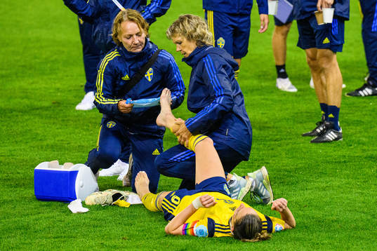 Annica Näsmark, physio treats Kosovare Asllani of Sweden