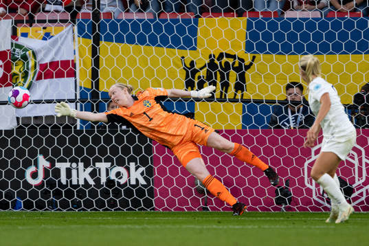 Beth Mead of England scores the 1-0 goal behind goalkeeper