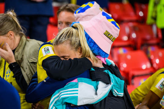 Nathalie Björn of Sweden is comforted by family in the