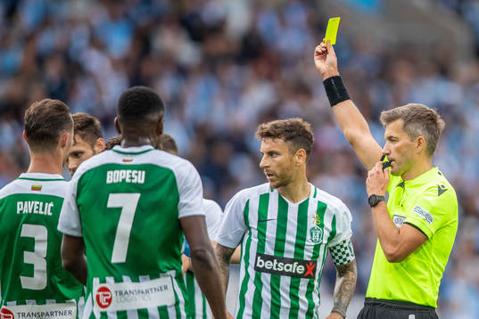Referee Kristo Tohver with a yellow card