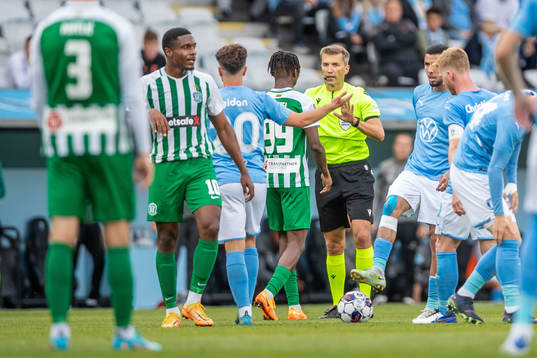 Referee Kristo Tohver and Kehinde Mathias Oyewusi of