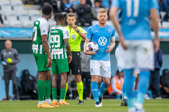 Referee Kristo Tohver and Kehinde Mathias Oyewusi of