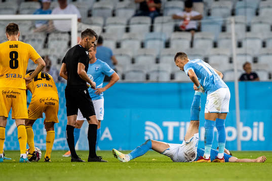 Erdal Rakip of Malmö FF gets help by Veljko Birmancevic