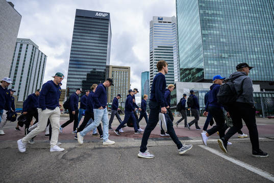 Players and staff of Sweden walk to the arena