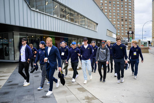 Players and staff of Sweden walk to the arena