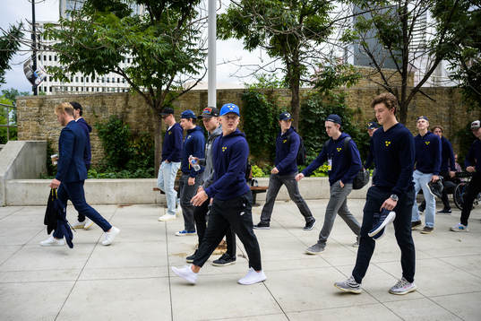 Players and staff of Sweden walk to the arena