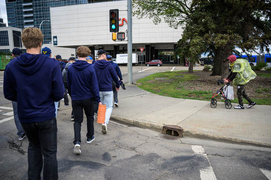 Players and staff of Sweden walk to the arena