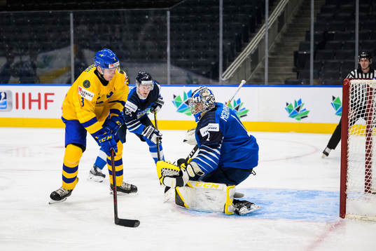 Helge Grans of Sweden scores 0-1 behind goaltender Leevi