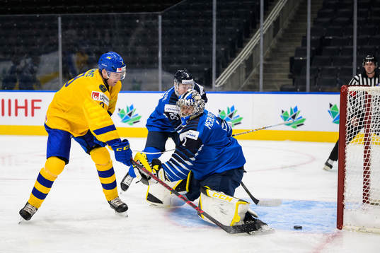Helge Grans of Sweden scores 0-1 behind goaltender Leevi
