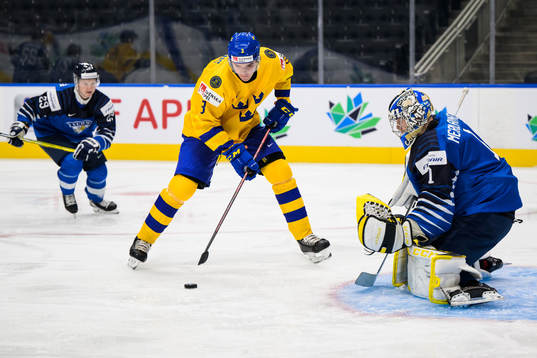 Helge Grans of Sweden scores 0-1 behind goaltender Leevi