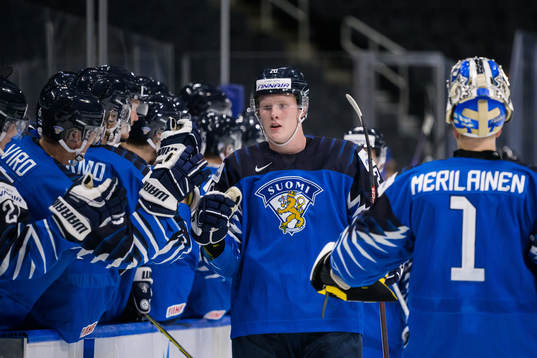 Samuel Helenius of Finland celebrates with teammates