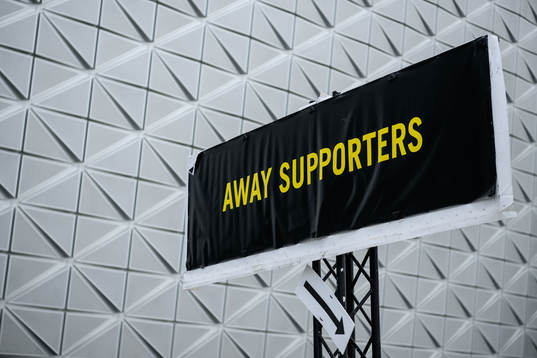 A sign with the text away supporters