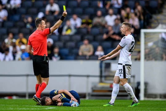 Bruno Dita of FK Shkendija is shown a yellow card from